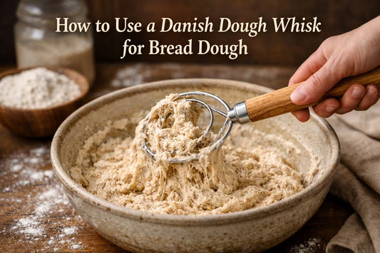 Danish dough whisk mixing sticky bread dough in a bowl